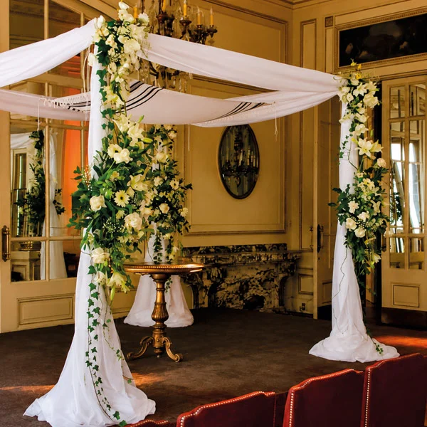 Telas drapeadas en ceremonia de matrimonio con techo draping y luces cálidas